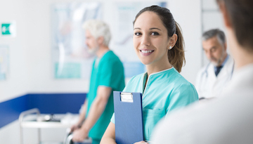 Young female medical student working at the hospital and medical staff, she is holding medical records